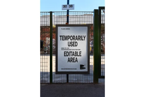 Outdoor poster mockup with editable design area on metal fence background ideal for advertising templates and graphic design projects urban setting.