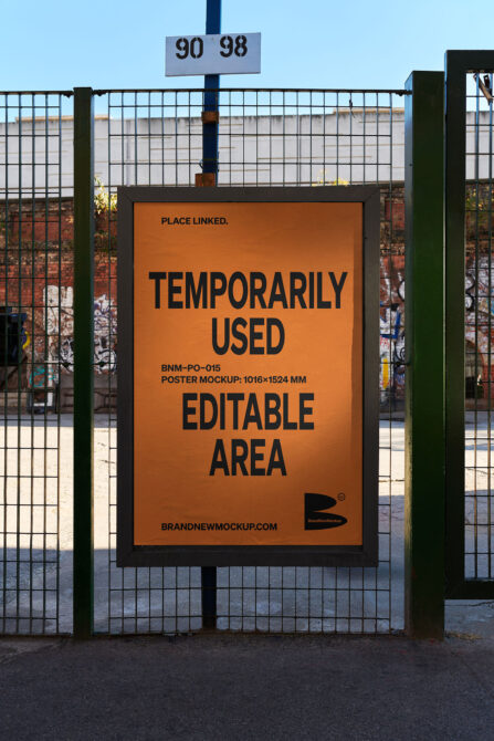 Orange poster mockup on fence with black text saying temporarily used editable area