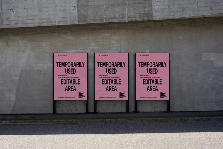 Three pink poster mockups hung in row on weathered concrete wall by street