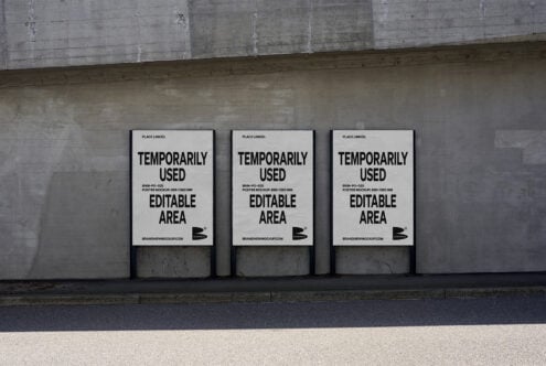 Urban poster mockup on concrete wall featuring three editable A1 frames for showcasing designs in realistic street setting ideal for graphic designers.