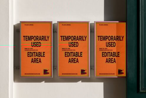 Three orange poster mockups on a wall with editable text areas. Ideal for designers seeking unique presentation templates or advertising graphics.