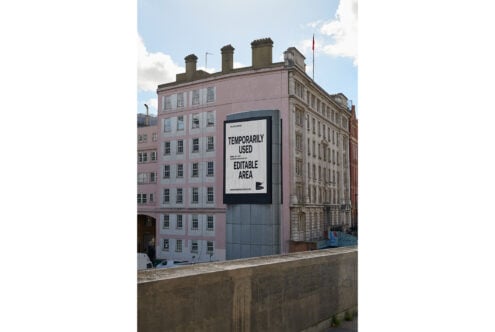 Urban billboard mockup on city building visible from street perfect for designers showcasing graphics or templates; high-resolution editable area.