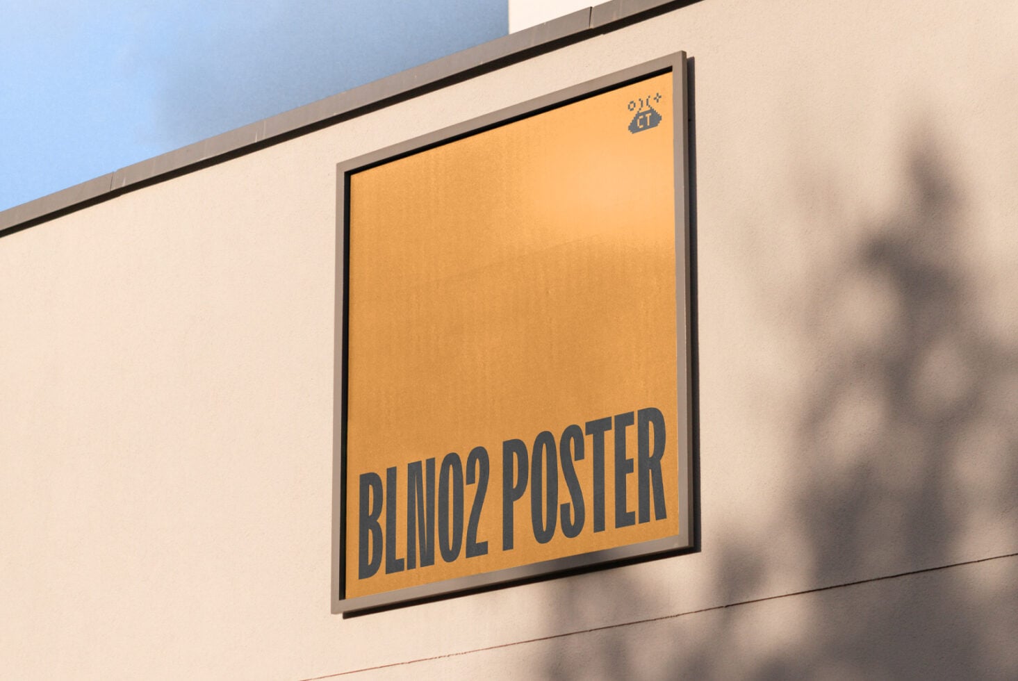 Framed golden-yellow poster on cream wall with blue text reading BLINO2 POSTER