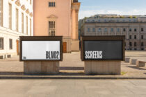 Two outdoor digital billboards in European plaza showing BLIN02 on white screen, SCREENS blank