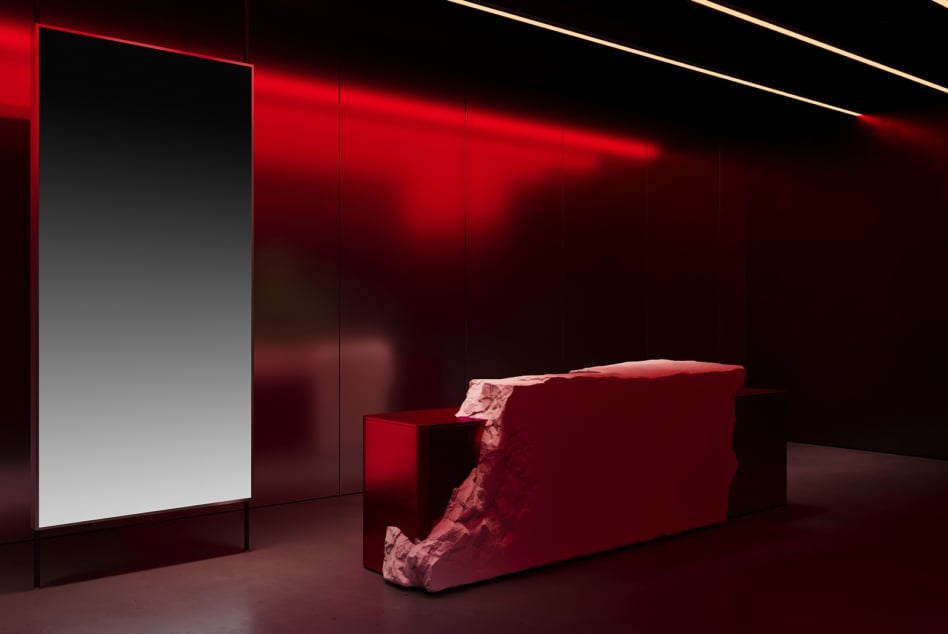 Modern interior design with red lighting reflects off smooth surfaces stone counter minimalist aesthetic architectural design inspiration designers