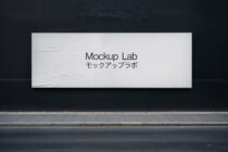 Clean white billboard mockup on dark urban storefront