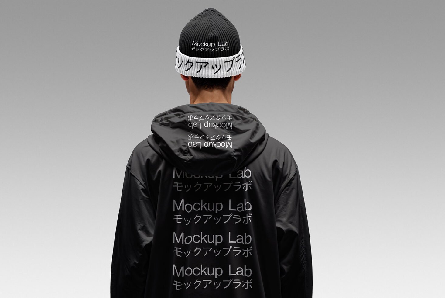Man wearing black hoodie and beanie with Mockup Lab text in English and Japanese suitable for designers. Ideal for clothing mockups and fashion templates.