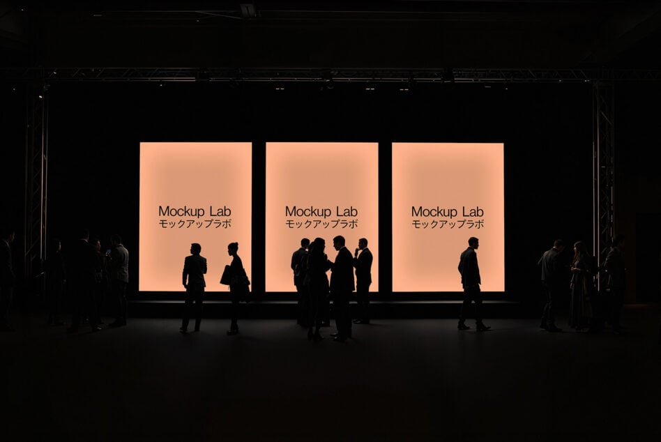 Backlit posters with Mockup Lab text displayed in a dimly lit room, silhouettes of people engaging, perfect for design mockups and presentations.