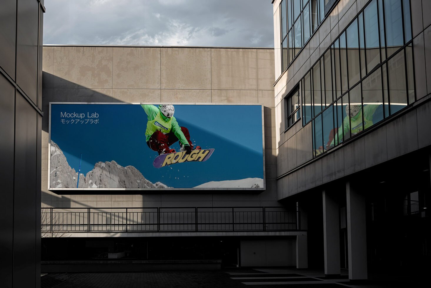 Urban billboard mockup featuring a vibrant snowboarder against snowy mountains for design presentations. Perfect for showcasing advertising graphics.