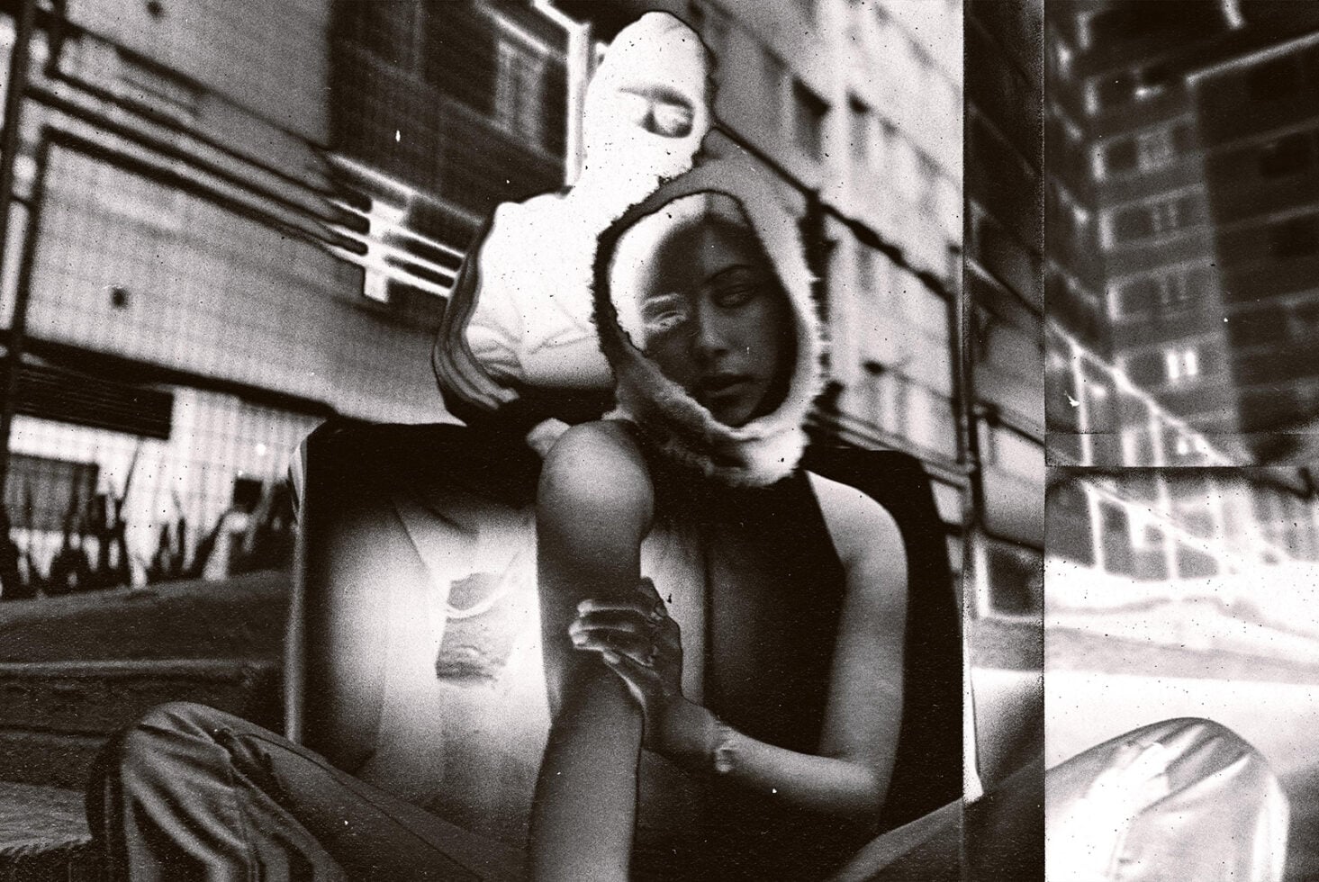Grainy black white street photo of two people split into vertical panels with film grain