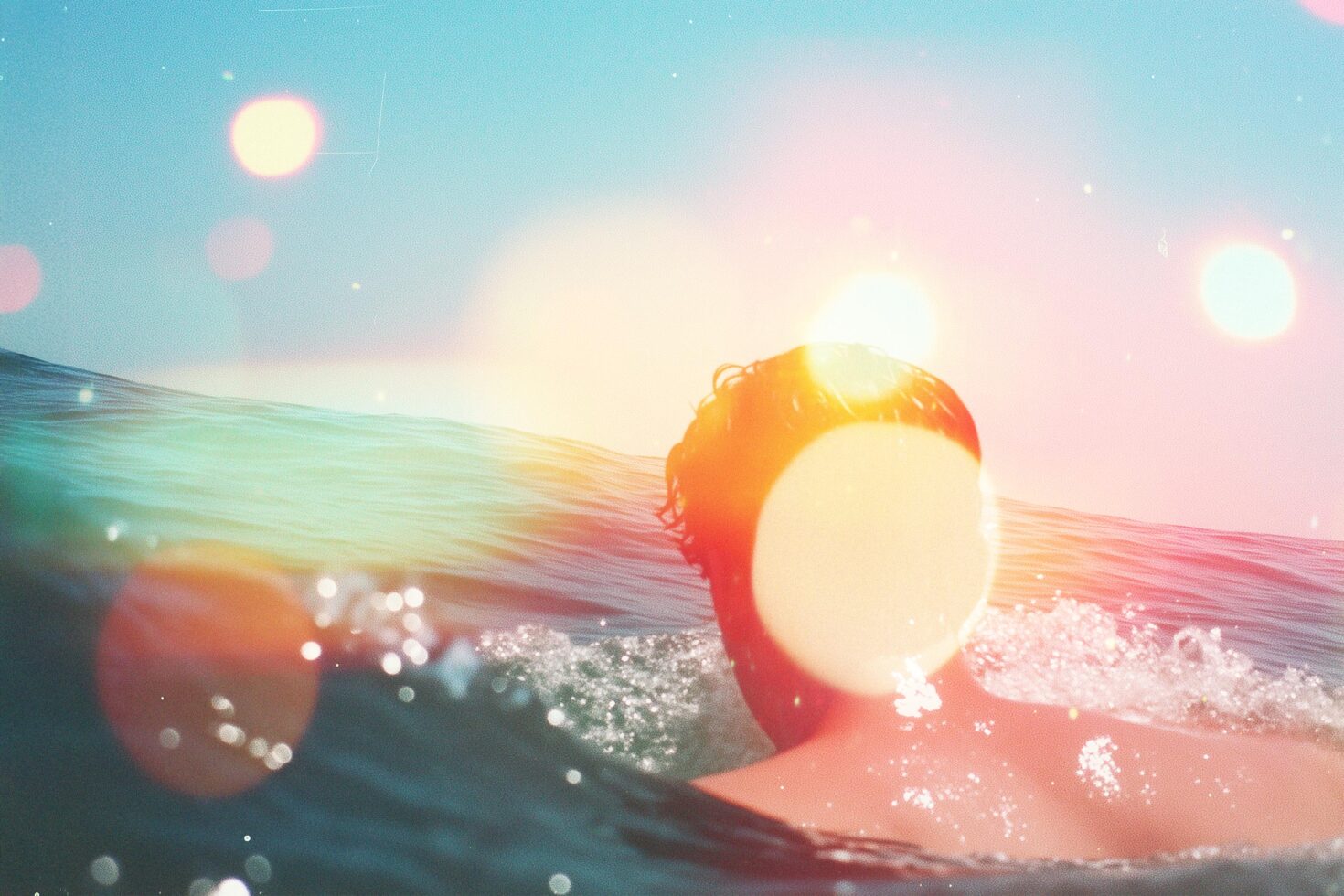 Surfer in ocean with sun flare effects creating a dreamy aesthetic perfect for designers looking for beach-themed graphics with vibrant colors and textures.
