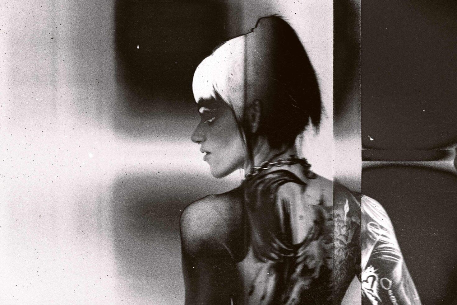 Monochrome film still of person with geometric shadow play, vintage frame border