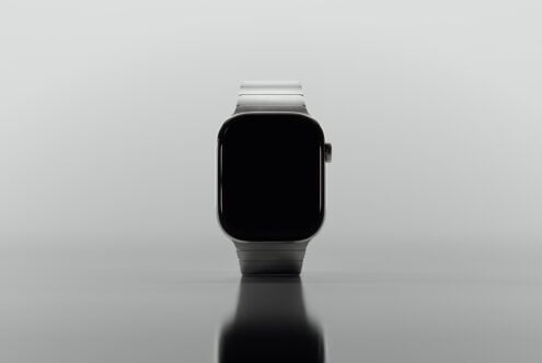 Smartwatch front view on reflective surface digital mockup for designers tech accessory sleek modern design wearable template high-resolution asset.