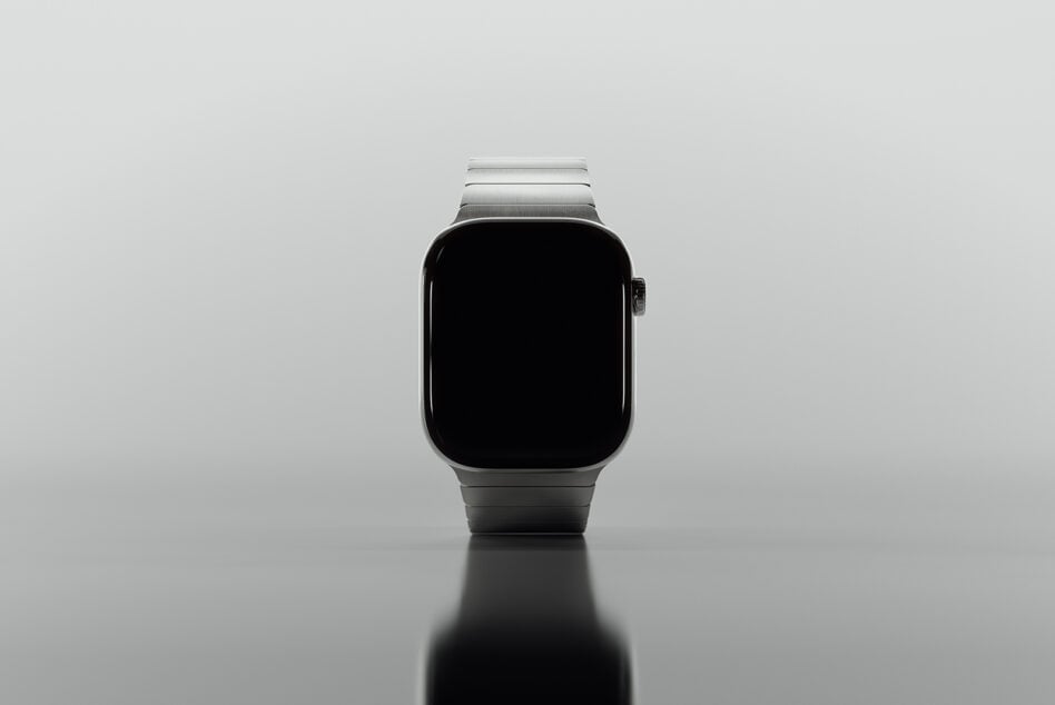Silver smartwatch with black display screen shot straight on