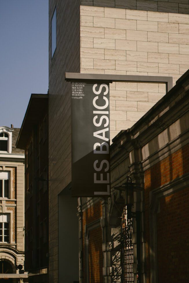 Urban banner mockup displaying Les Basics in a city setting. Ideal for designers seeking realistic templates, signage, graphics for outdoor use.