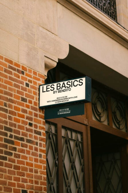 Wall-mounted sign mockup on brick building exterior suitable for stores and businesses. Ideal for design presentations and marketing visuals.