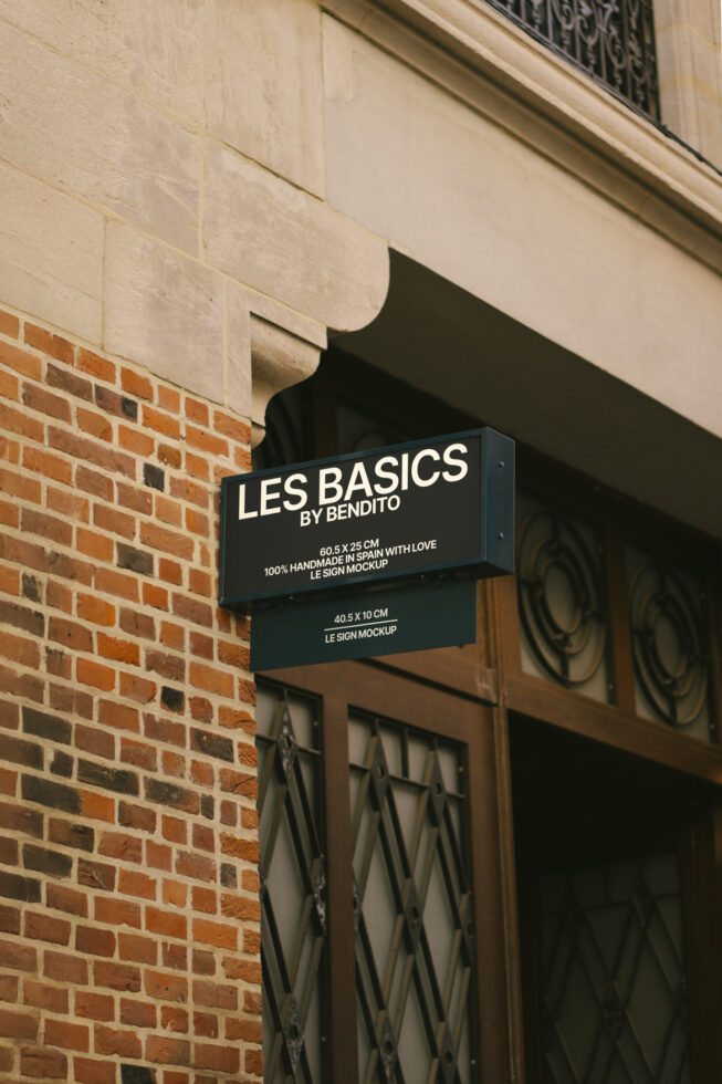 Wall-mounted shop sign mockup on brick facade for store branding. Ideal for use in designing signage templates. Keywords: mockup, sign, branding