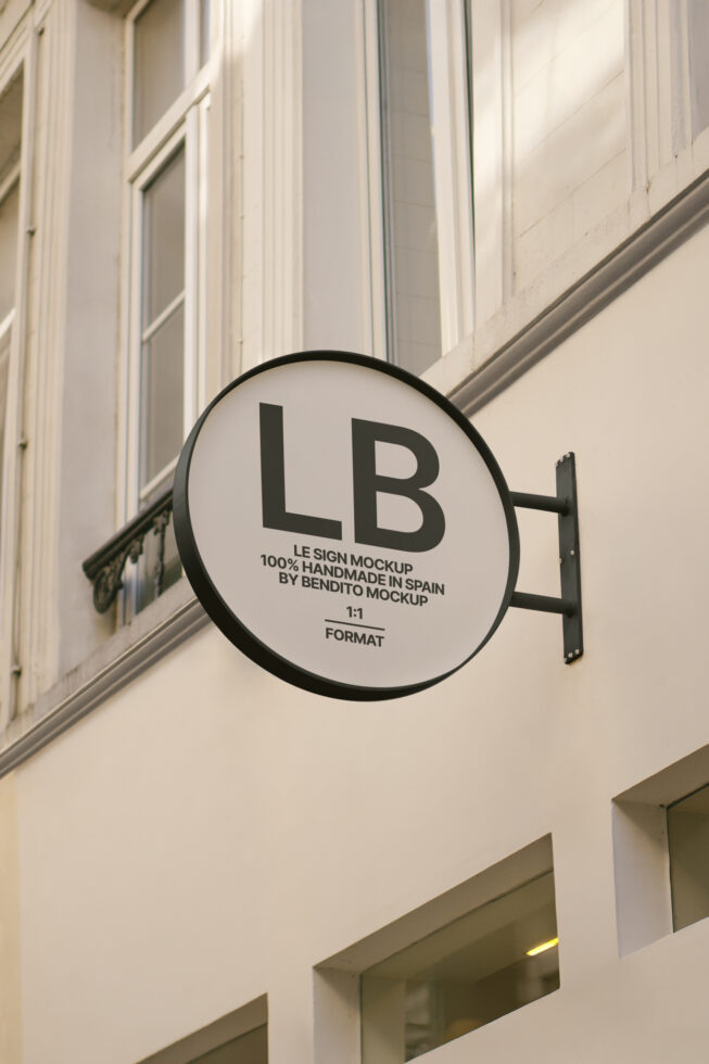 Urban wall-mounted round sign mockup on a building facade, ideal for branding design presentations. Perfect for designers seeking realistic signage graphics.