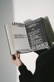 Open magazine spread showing Les Basics branding on cream left page with dark right page layout
