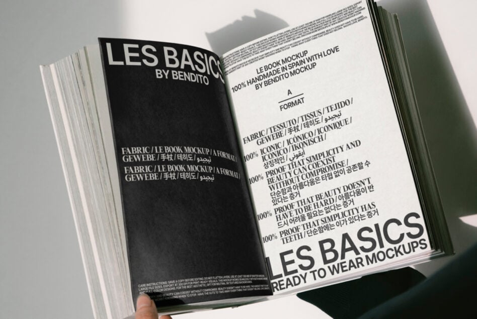 Magazine mockup open showing Les Basics branding across cream left page, dark right page