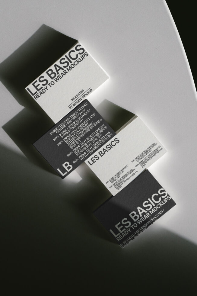 Three stacked clothing tags with Les Basics branding in black, white, grey with care info