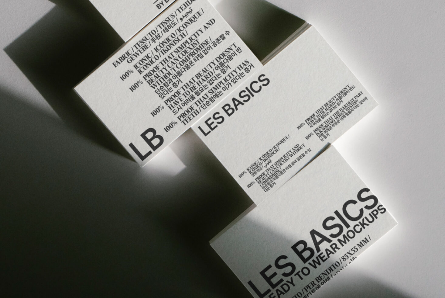Close-up of folded clothing tags showing Les Basics care instructions in multiple languages