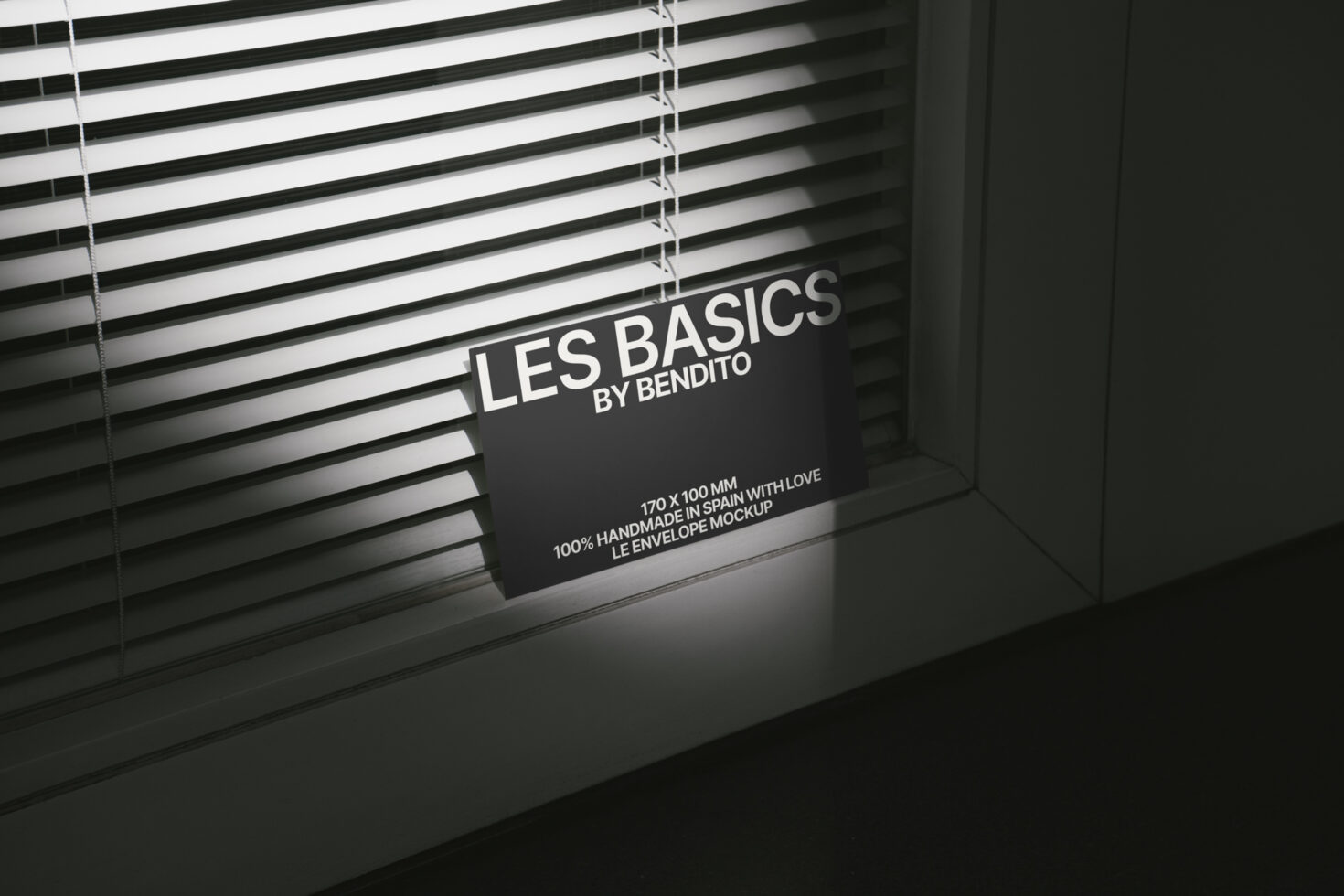Mockup of a minimalist card with Les Basics by Bendito text leaning against blinds suitable for design projects templates photography SEO keywords.