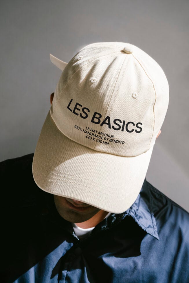 Beige cap mockup with LES BASICS text for design templates. Ideal for showcasing branding or logo designs on casual wear. High-quality digital asset.