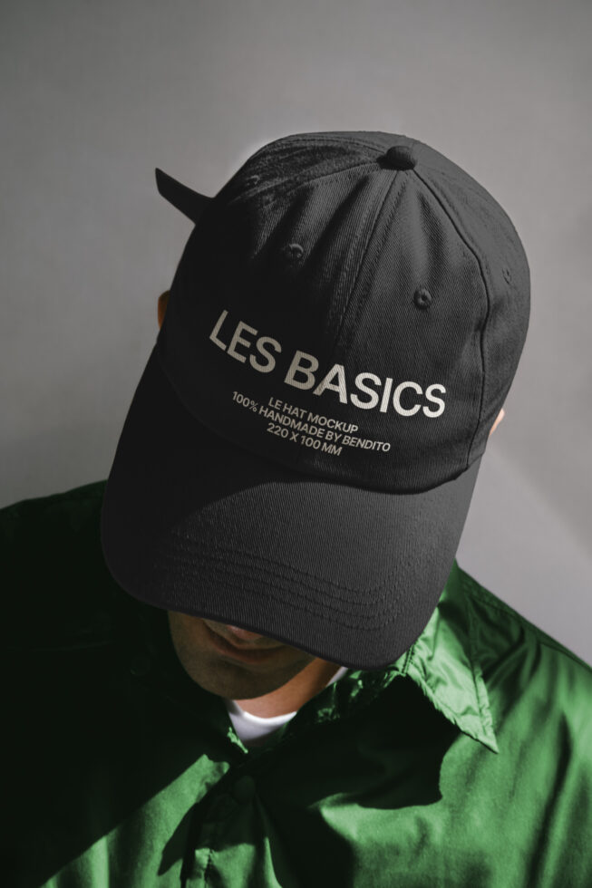 Black baseball cap mockup on person wearing green shirt. High-quality apparel template, suitable for showcasing designs. Keywords: mockup, cap, template.