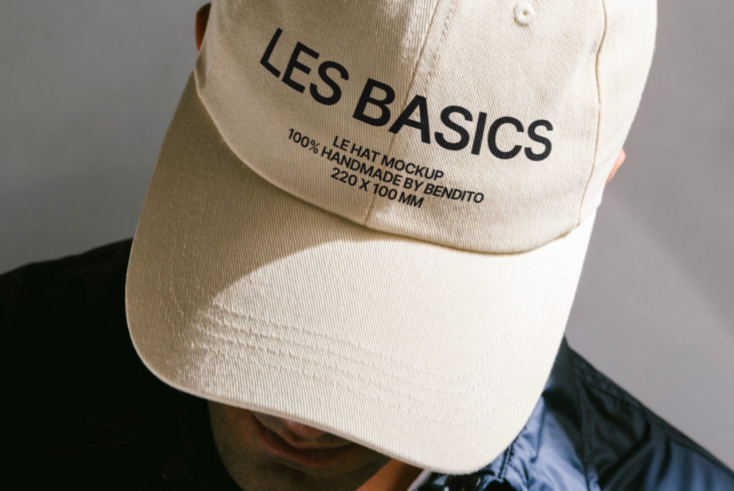 Beige cap mockup with text LES BASICS. Ideal for fashion designers. High-resolution customizable hat template for branding and design projects.