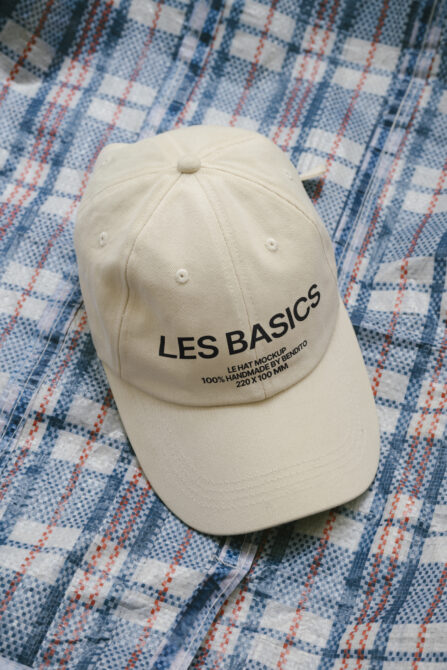Beige baseball cap on checkered fabric background useful for apparel mockups fashion design templates and digital graphics project presentations.