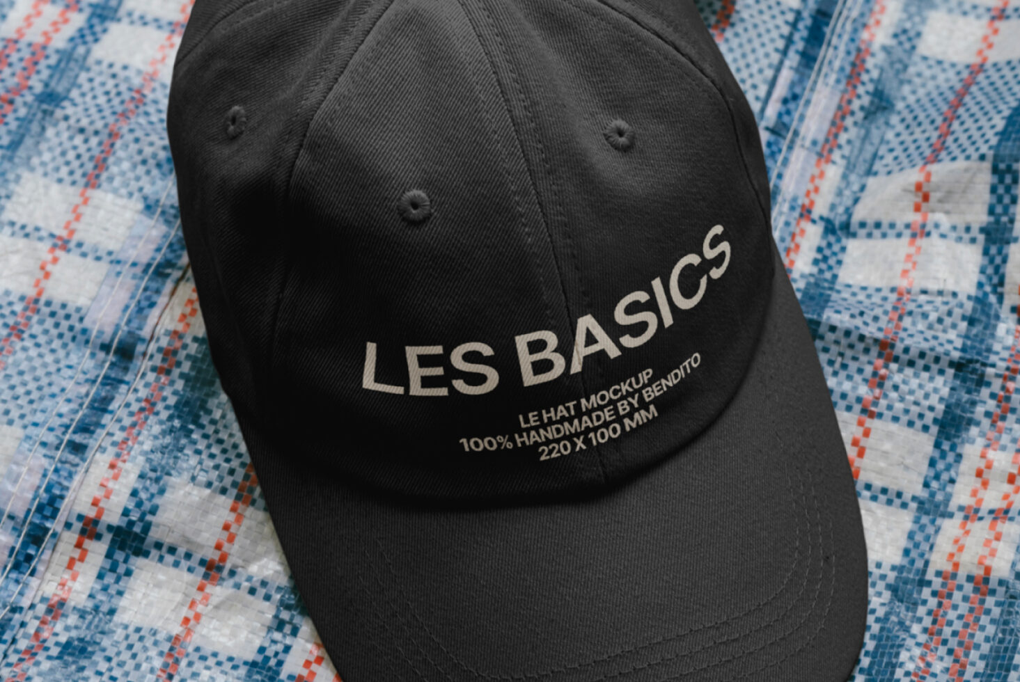 Close up of black cap visor showing Les Basics embroidery detail