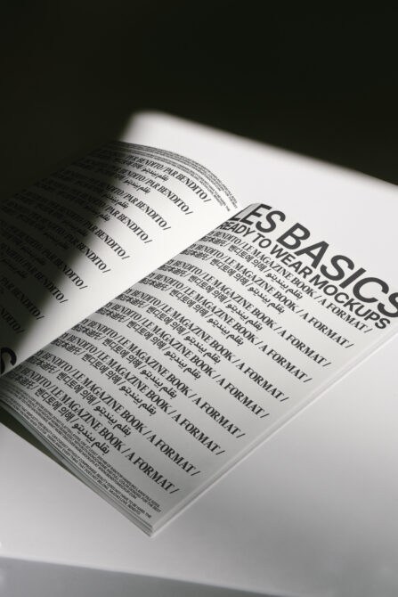 Open magazine mockup showing two pages with bold typography layout