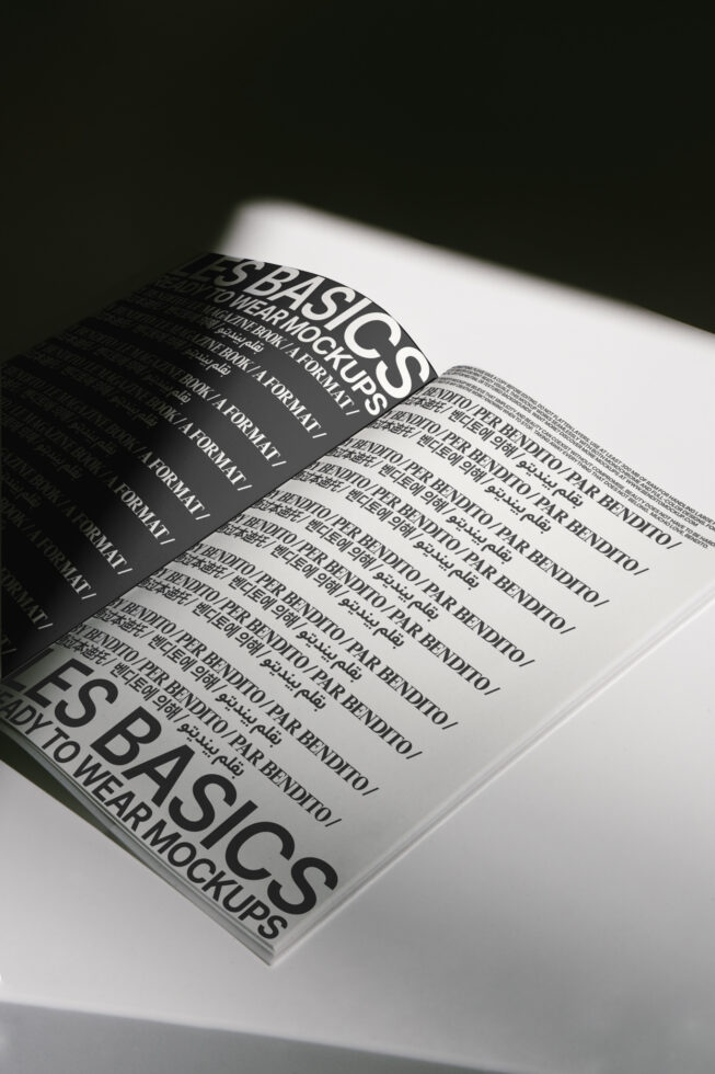Magazine spread mockup with repeating text under dramatic lighting