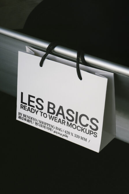 Shopping bag mockup hanging on a rail with branding design. Perfect for designers needing high-quality templates for showcasing retail graphics.