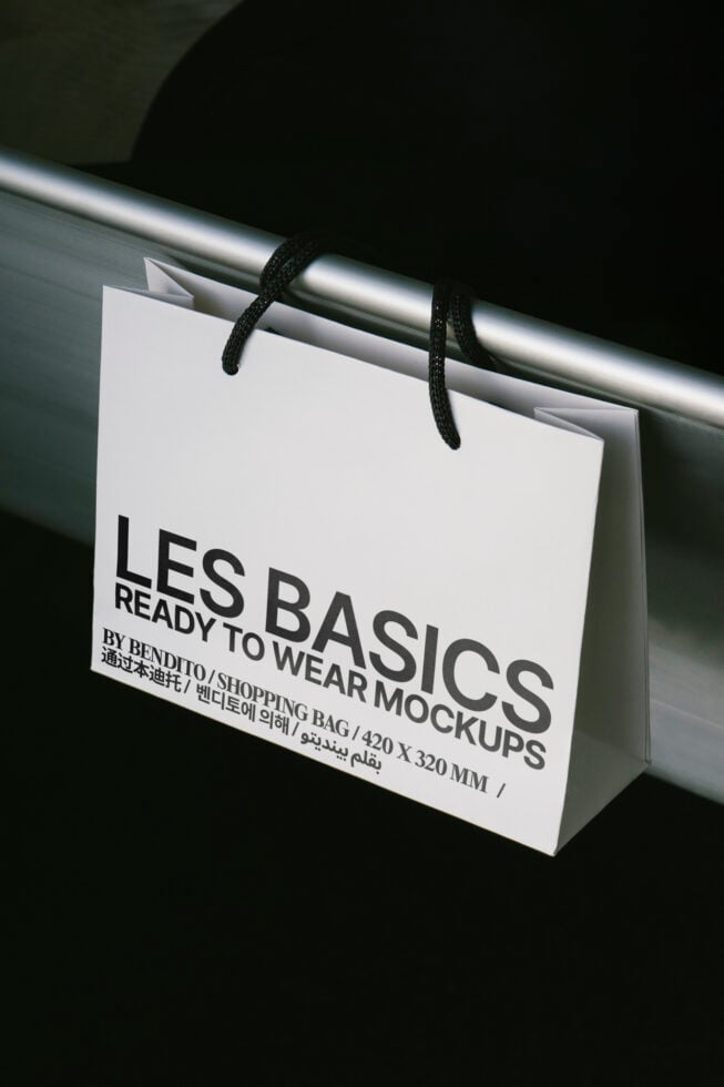 Shopping bag mockup hanging on a rail with branding design. Perfect for designers needing high-quality templates for showcasing retail graphics.