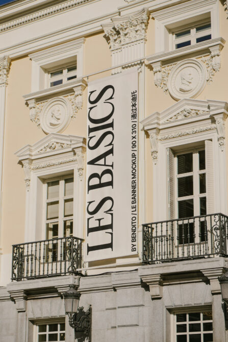 Wide building front view with centered banner between classical window frames
