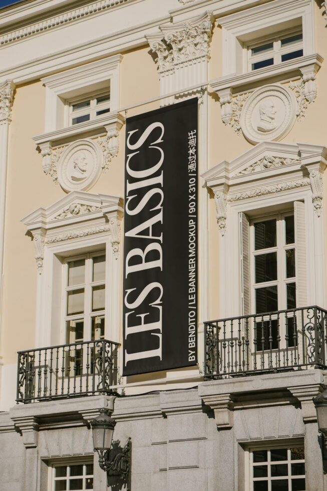 Large facade banner on cream building with wrought iron balconies below