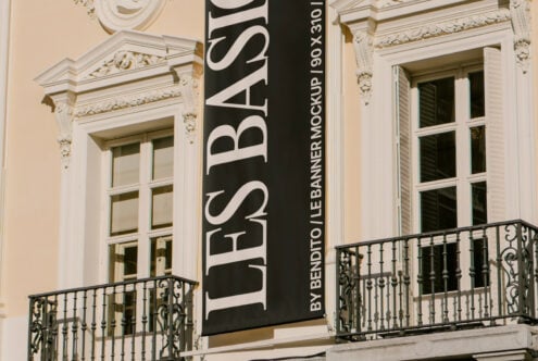 Elegant building facade with a vertical black banner displaying text. Perfect for urban design mockups or architectural templates for designers.