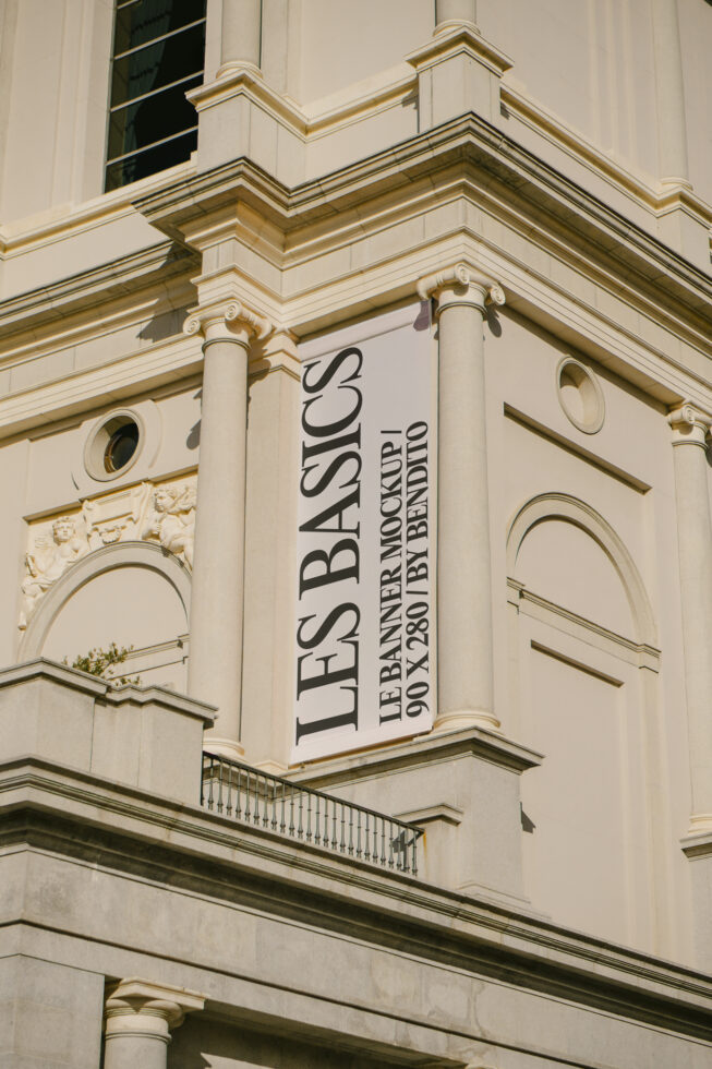 Vertical banner mockup on neoclassical building exterior showcasing Les Basics font ideal for design presentations and architectural mockup projects.