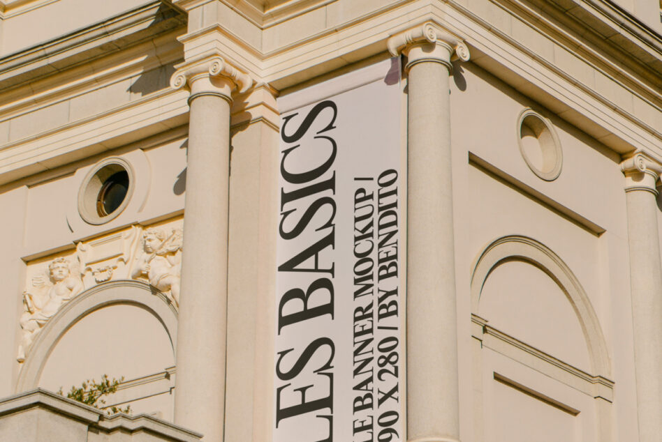 Building banner shot from below showing ornamental capitals over windows