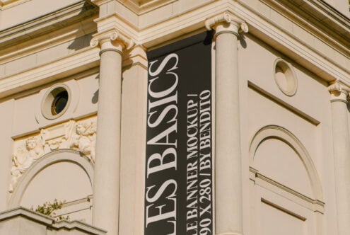 Vertical banner mockup on neoclassical building facade with columns and sculpted cherubs. Ideal for design presentations signage graphics mockups templates.