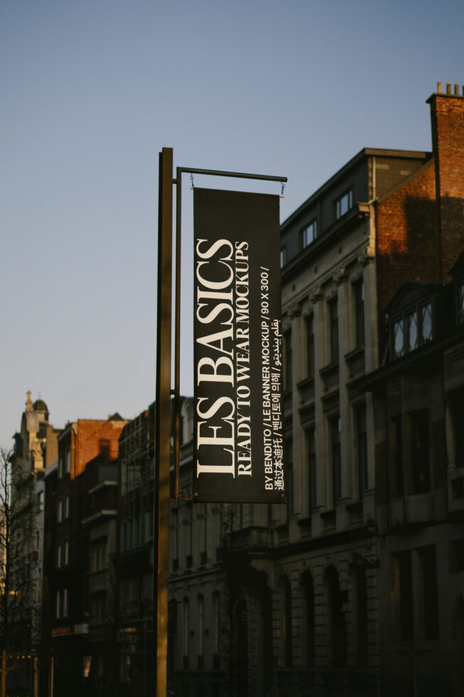 Dark street banner hanging from pole showing Les Basics Ready To Wear Mockups