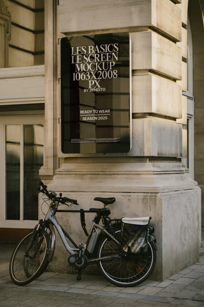 Urban poster mockup on a stone wall with bicycle. Design template for 2025 fashion season. Perfect for graphic designers seeking realistic outdoor visuals.