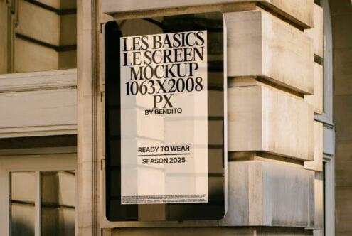 Outdoor screen mockup sign on stone building, displaying Les Basics poster. Template for designers. Ideal for showcasing graphic design projects.