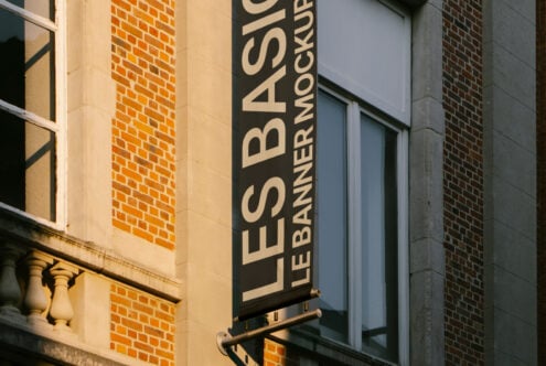 Vertical banner mockup on urban building wall ideal for design presentations and marketing visuals suitable for graphic and template designers.