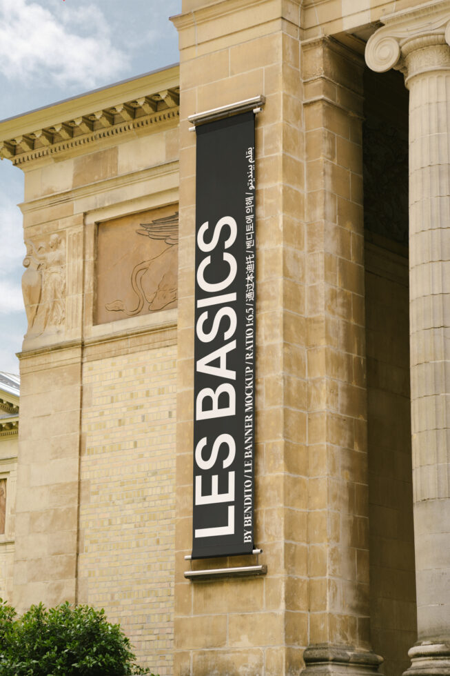Large vertical banner mockup on classical building wall showcasing LES BASICS suitable for designers graphics templates architecture display.