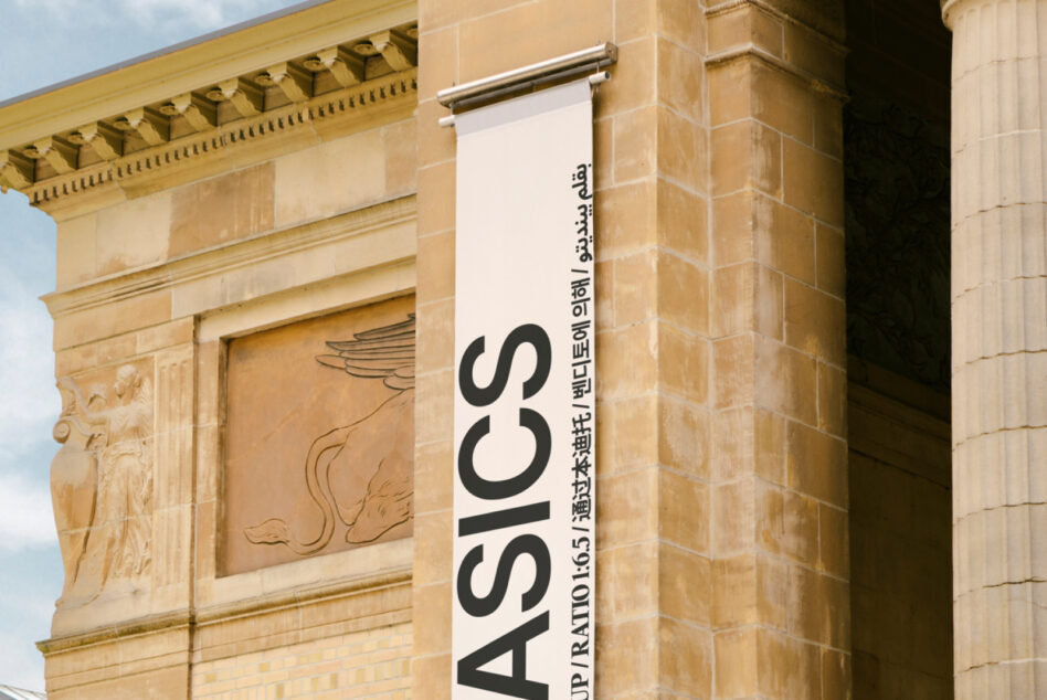 White vertical banner mockup on sandstone classical building with black large text ASICS
