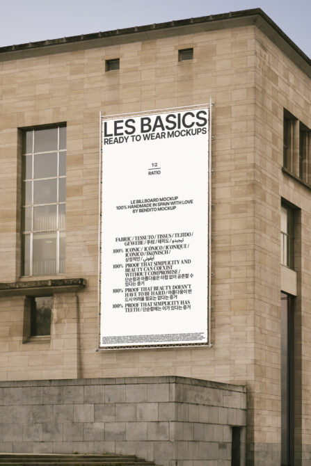 Les Basics Ready to Wear Mockups billboard on sandstone building exterior with light design
