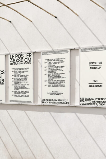 White hanging posters with black text on white greenhouse backdrop, showing Les Basics by Bendito collection 48x80cm